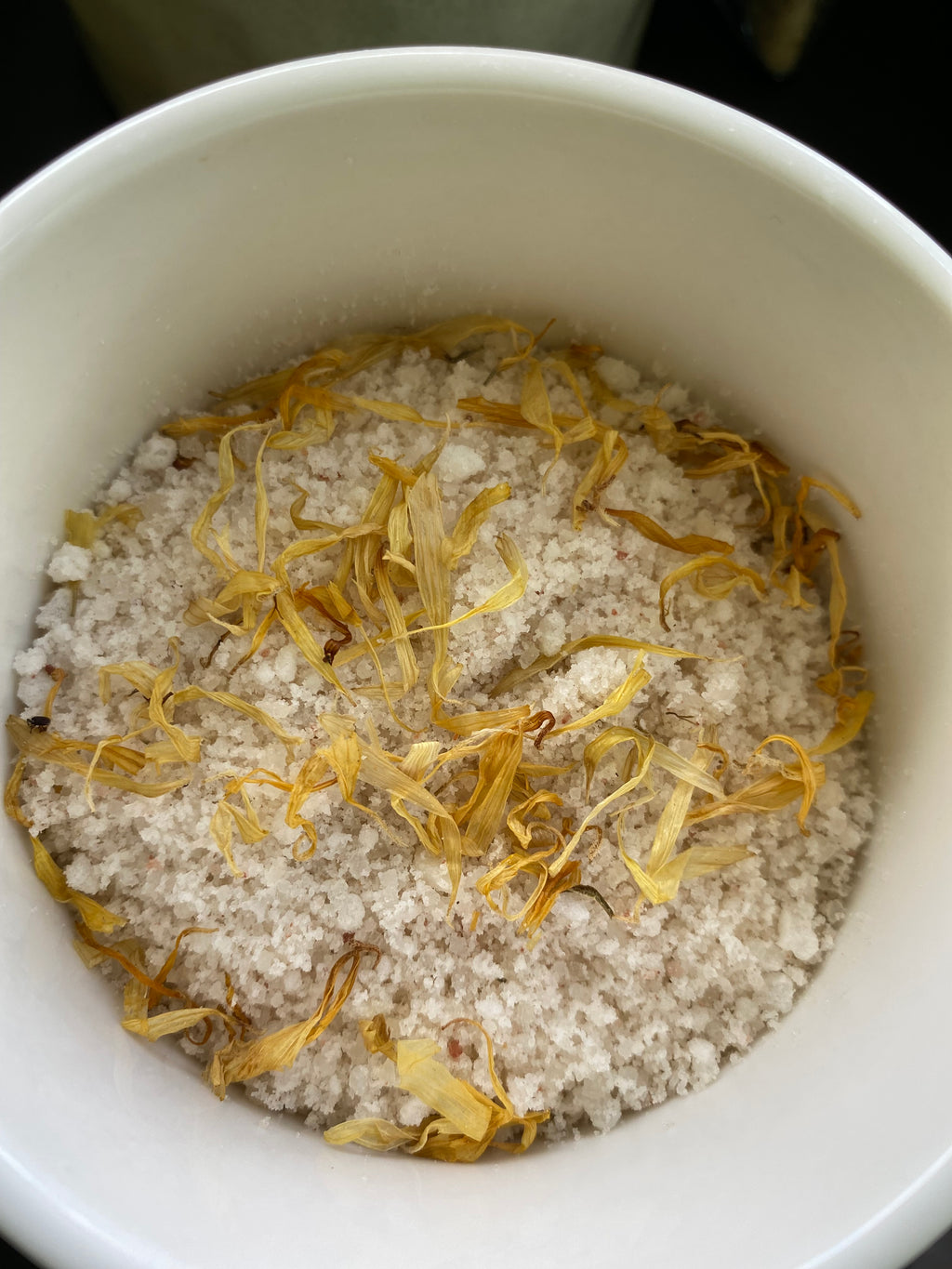 Blends of Calendula Flowers Himalayan Sea Salt Epsom Salt Jojoba Olive Shae Butter Oils with Essential Oils of Ylang Ylang Lima Tea Tree and Geranium.