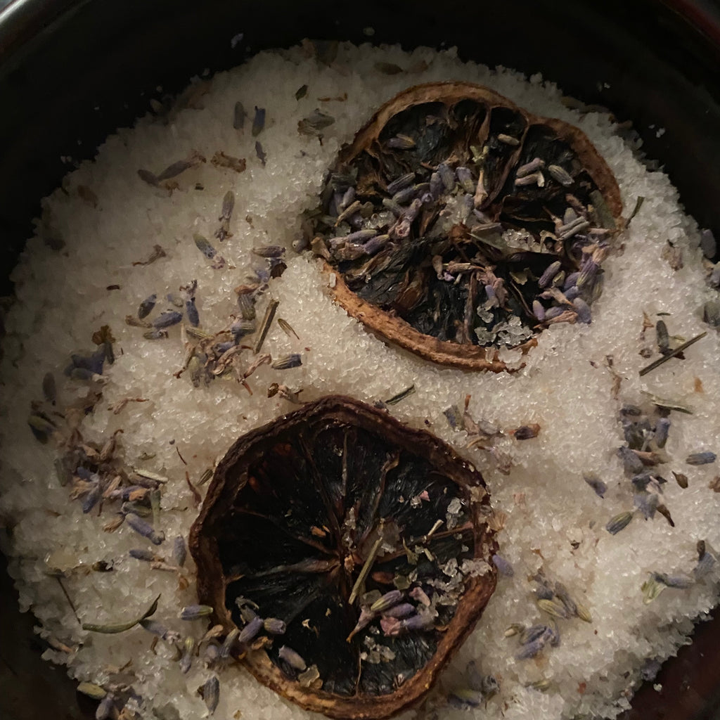 Extra Large Canister of Tranquil scents of Eucalyptus Tea Tree Rosemary Geranium with Lavender Oils with Lavender Flowers and Topped with Lemon Slices. Made with Epsom Salt Pink Sea Salt Jojoba Sunflower Olive and Shae Butter Oil. Has a 5x5 Wooden Topper.