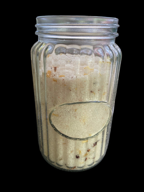 Clear Vintage Mason Jar Filled with Clove Lavender Chamomile Tea Tree and Geranium Essential Oils has Dead Sea Salt Pink Himalayan Sea Salt has Olive Jojoba Sunflower and Shae Butter Oils. Blended with Albizzide Flowers.