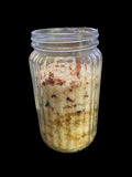 Clear Vintage Mason Jar Filled with Clove Lavender/Chamomile Tea Tree and Geranium Essential Oils has Dead Sea Salt Pink Himalayan Sea Salt has Olive Jojoba Sunflower and Shae Butter Oils. Has Lily Flowers with Calendula Flowers.