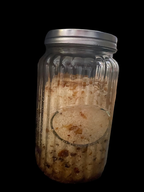 Clear Vintage Mason Jar Filled with Clove Lavender Chamomile Tea Tree and Geranium Essential Oils has Dead Sea Salt Pink Himalayan Sea Salt with Olive Jojoba Sunflower and Shae Butter Oils. Blends of Roses Jasmine and Albizzide Flowers.